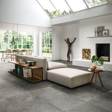 Modern white livingroom with large cement look porcelian tile