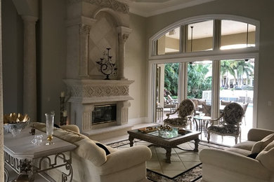 Tuscan formal and open concept marble floor living room photo in Miami with gray walls, a standard fireplace and a plaster fireplace