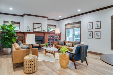 Inspiration for a mid-sized craftsman open concept dark wood floor and brown floor living room remodel in Raleigh with white walls, a standard fireplace and a wood fireplace surround