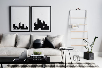 Example of a minimalist living room design in Melbourne with white walls