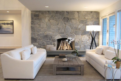 Example of a mid-sized beach style formal and open concept light wood floor living room design in New York with beige walls, a standard fireplace and a stone fireplace