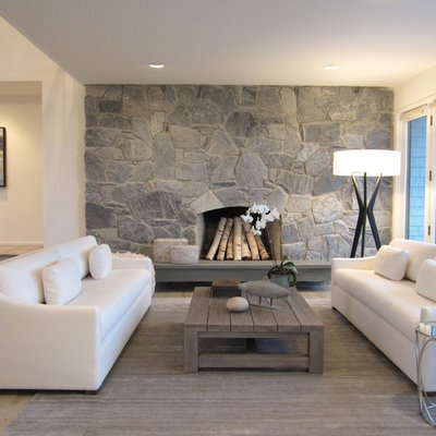 Example of a mid-sized beach style formal and open concept light wood floor living room design in New York with beige walls, a standard fireplace and a stone fireplace