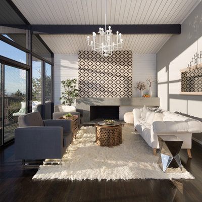 Example of a mid-sized danish open concept and formal dark wood floor and brown floor living room design in San Francisco with a standard fireplace, a concrete fireplace, gray walls and no tv
