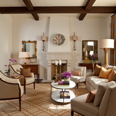 Inspiration for a large mediterranean enclosed and formal dark wood floor and brown floor living room remodel in Santa Barbara with beige walls, a standard fireplace, no tv and a plaster fireplace