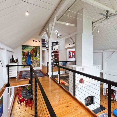 Inspiration for a farmhouse loft-style living room remodel in Philadelphia with white walls