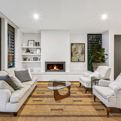 Inspiration for a mid-sized contemporary open concept and formal light wood floor and beige floor living room remodel in Sydney with white walls, a ribbon fireplace and a plaster fireplace
