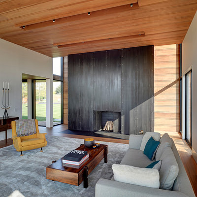 Inspiration for a modern formal and open concept medium tone wood floor living room remodel in New York with white walls, a standard fireplace and a metal fireplace