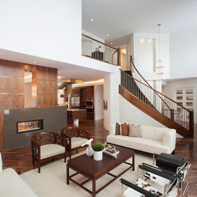 Trendy open concept living room photo in Calgary with white walls and a two-sided fireplace