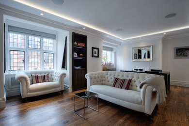 Design ideas for a classic living room in London with dark hardwood flooring.