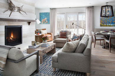 Inspiration for a transitional open concept light wood floor and gray floor living room remodel in Denver with white walls, a standard fireplace and a shiplap fireplace