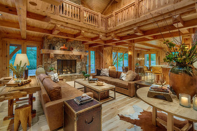 Living room - rustic open concept light wood floor living room idea in Sacramento with a standard fireplace and a stone fireplace