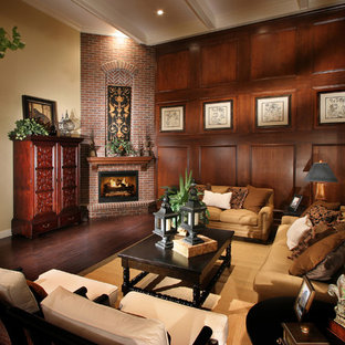 Living room - traditional medium tone wood floor living room idea in Denver with beige walls, a corner fireplace, a brick fireplace and no tv