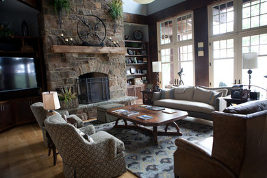 Cette image montre un salon traditionnel de taille moyenne et fermé avec une salle de réception, un mur blanc, parquet clair, une cheminée standard, un manteau de cheminée en pierre et un téléviseur indépendant.