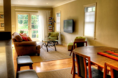 Midcentury open plan living room in Portland with medium hardwood flooring.