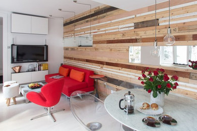 This is an example of an eclectic open plan living room in London with multi-coloured walls and plywood flooring.