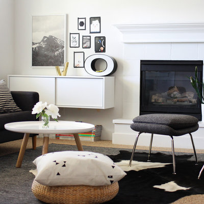 Living room - scandinavian living room idea in Boise with white walls and a standard fireplace