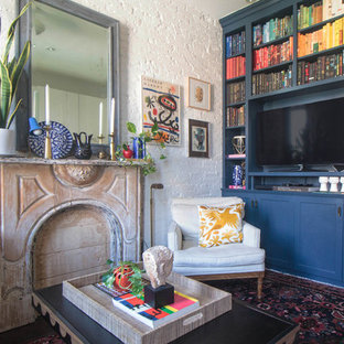 Living room library - eclectic dark wood floor living room library idea in New York with white walls and a media wall