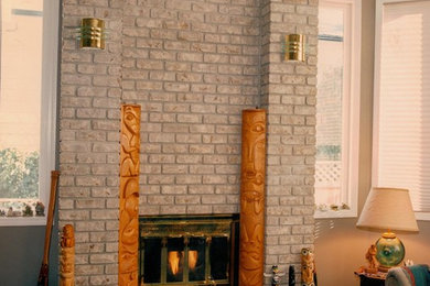 Inspiration for a carpeted living room remodel in Vancouver with beige walls, a standard fireplace and a brick fireplace