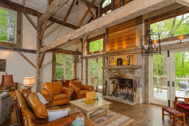 Example of a mountain style formal and open concept living room design in Atlanta with beige walls, a standard fireplace, a stone fireplace and no tv