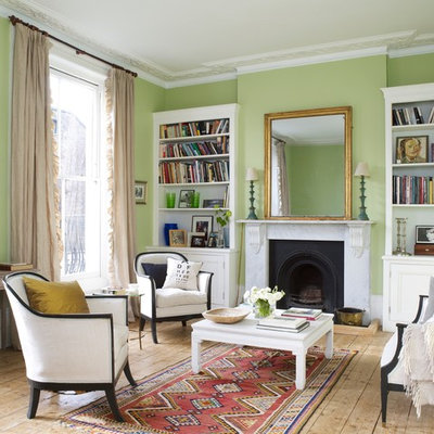 Living room - mid-sized traditional formal light wood floor living room idea in New York with green walls, a standard fireplace, a stone fireplace and no tv