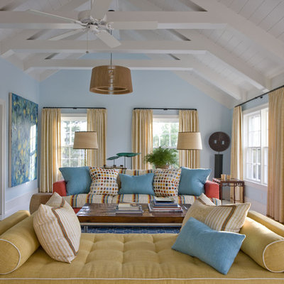 Example of an eclectic enclosed living room design in New York with blue walls and no tv