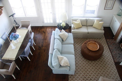 Example of a mid-sized beach style open concept dark wood floor living room design in Boston with white walls, a standard fireplace, a brick fireplace and a wall-mounted tv