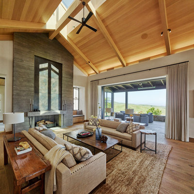 Mountain style formal and open concept medium tone wood floor and brown floor living room photo in San Francisco with a standard fireplace, a concrete fireplace and white walls