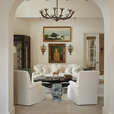 Living room - mediterranean enclosed light wood floor living room idea in Bridgeport with white walls