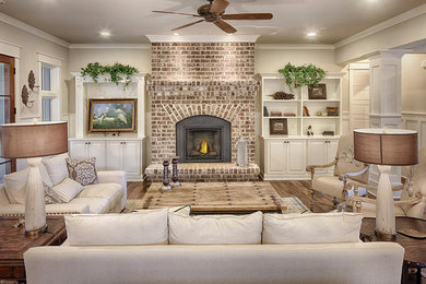 Inspiration for a large transitional formal and enclosed medium tone wood floor and brown floor living room remodel in Other with gray walls, a standard fireplace, a brick fireplace and no tv