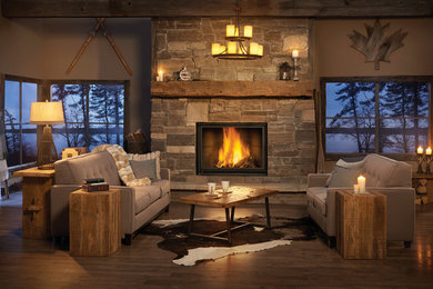Example of a large mountain style formal and open concept dark wood floor and brown floor living room design in Other with brown walls, a standard fireplace, a stone fireplace and no tv