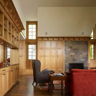 Inspiration for a mid-sized craftsman enclosed and formal medium tone wood floor living room remodel in Chicago with beige walls, a standard fireplace, a stone fireplace and no tv