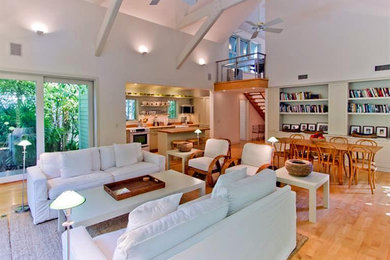 Living room - small loft-style light wood floor living room idea in Miami with white walls