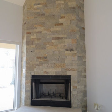 Natural Stone Veneer Indoor fireplace with Angled Walls and Ceiling.