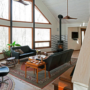 Mid-sized danish open concept light wood floor living room photo in DC Metro with white walls, a wood stove and a tile fireplace
