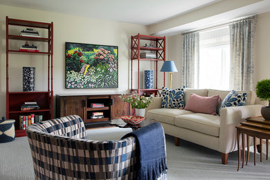 This is an example of a traditional living room in Boston with beige walls and grey floors.