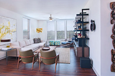 Example of a trendy formal medium tone wood floor living room design in Austin with white walls