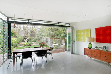 Photo of a contemporary dining room in Sydney with concrete flooring.