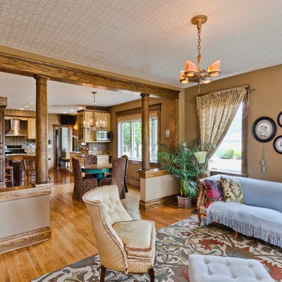 Large ornate formal and open concept light wood floor and brown floor living room photo in Chicago with brown walls, a concealed tv and no fireplace
