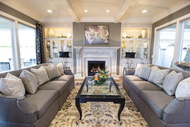 Inspiration for a mid-sized timeless formal and open concept medium tone wood floor living room remodel in Portland with beige walls, a standard fireplace and a plaster fireplace