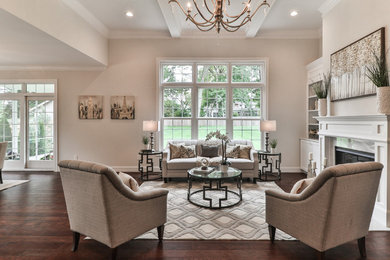 Large traditional formal open plan living room in St Louis with beige walls, dark hardwood flooring, a standard fireplace, a tiled fireplace surround, no tv and brown floors.