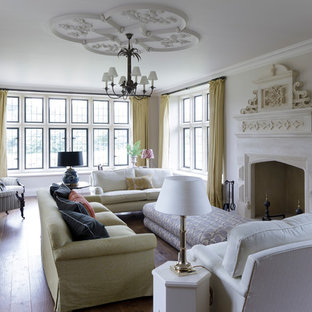 Traditional formal living room in Oxfordshire with beige walls, medium hardwood flooring and a standard fireplace.