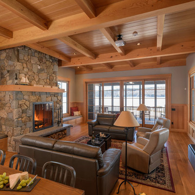 Living room - rustic formal and open concept medium tone wood floor and brown floor living room idea in Boston with green walls, a standard fireplace and a stone fireplace