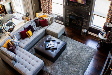 Living room - large transitional loft-style dark wood floor living room idea in Cleveland with gray walls, a ribbon fireplace, a stone fireplace and a media wall