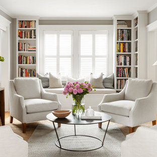 Living room - transitional enclosed medium tone wood floor and brown floor living room idea in Boston with gray walls