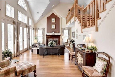 Inspiration for a mid-sized timeless formal and open concept light wood floor and beige floor living room remodel in Other with white walls, a standard fireplace, a brick fireplace and no tv