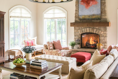 Living room - mid-sized mediterranean open concept medium tone wood floor and brown floor living room idea in San Francisco with beige walls, a standard fireplace, a stone fireplace and a concealed tv