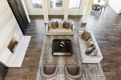 Inspiration for a huge contemporary open concept medium tone wood floor living room remodel in Houston with white walls, a standard fireplace, a stone fireplace and a concealed tv