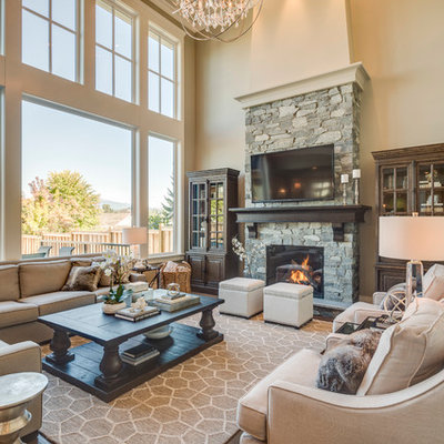 Inspiration for a mid-sized timeless open concept dark wood floor living room remodel in Vancouver with beige walls, a standard fireplace, a stone fireplace and a wall-mounted tv