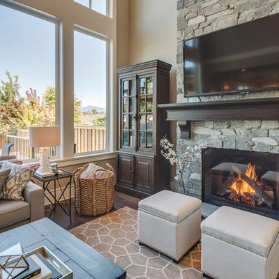 Inspiration for a mid-sized timeless open concept dark wood floor living room remodel in Vancouver with beige walls, a standard fireplace, a stone fireplace and a wall-mounted tv