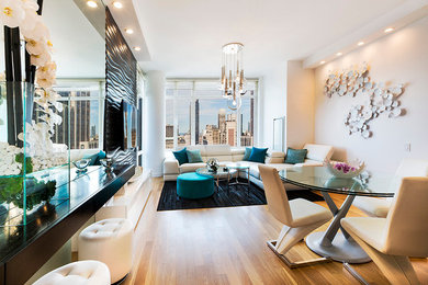 Inspiration for a contemporary light wood floor living room remodel in New York with white walls and a media wall